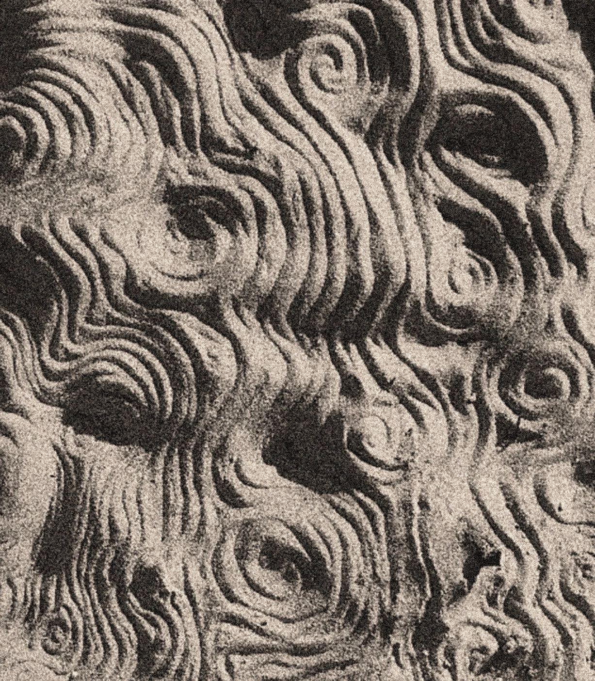 An abstract black and white pattern with swirling lines and concentric circles creating a textured, hypnotic design.