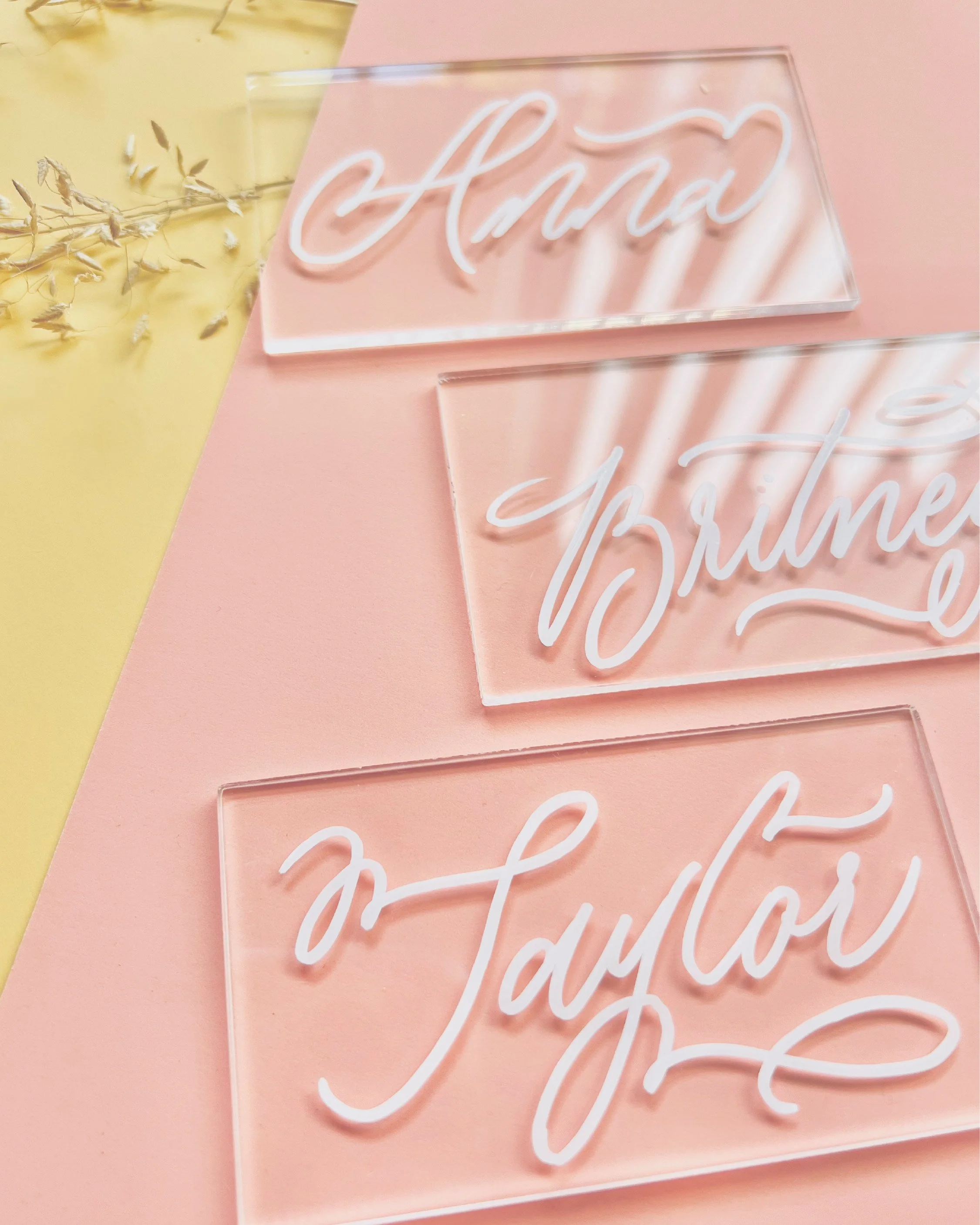 Close-up photo of a pink neon sign with cursive writing on a pink background, partially visible, reading 'Mama' and 'Breathe'.