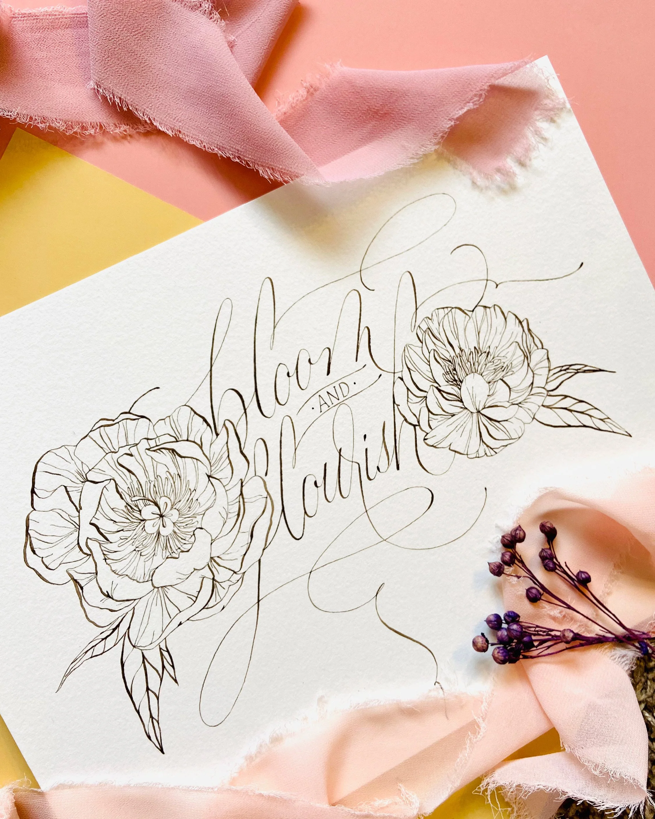 A floral illustration on paper with pink and yellow paper textured background, accompanied by a small bouquet of purple dried flowers wrapped in pink fabric.