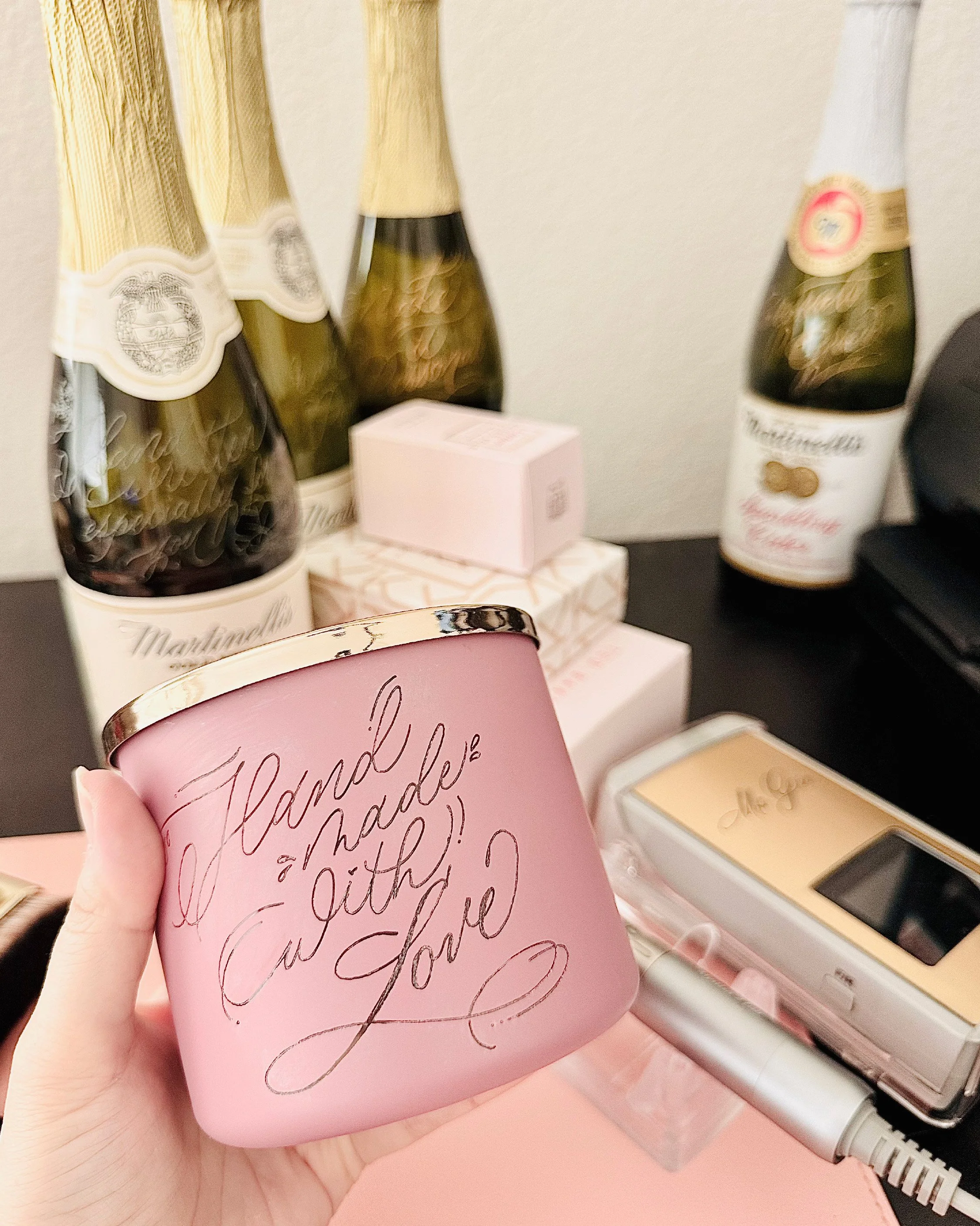 A pink mug with cursive writing that says "Thank you for your love" held in a person's hand.