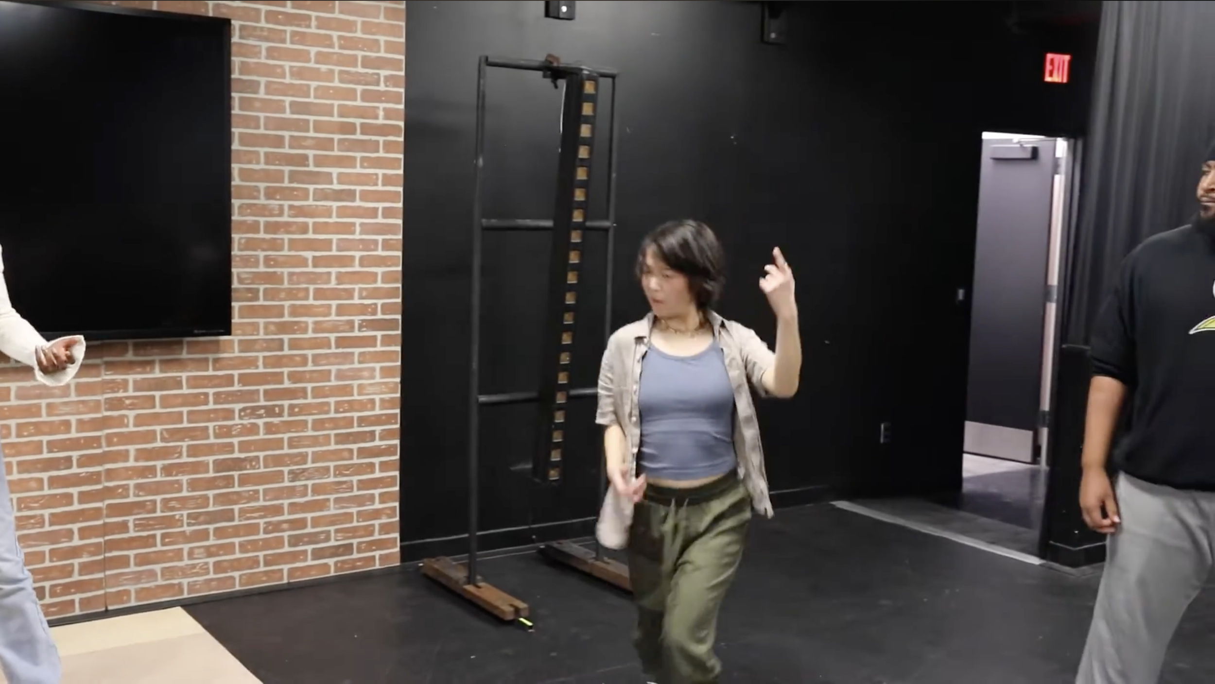 A person dancing on a stage, closeup.