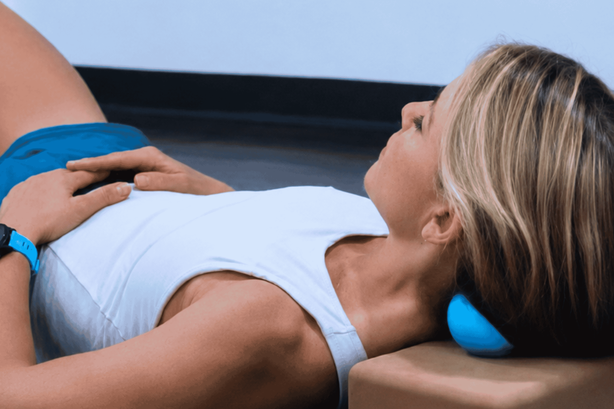 Student using a myofascial release ball at the neck during Yin Yoga training at Yoga Pod Tucson