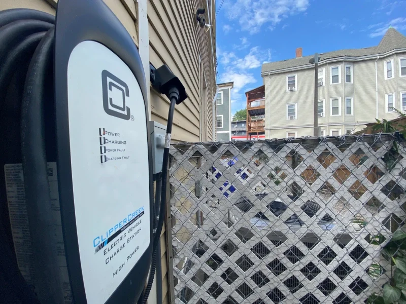 Photo of electric car charger mounted against the side of ESWA's building.