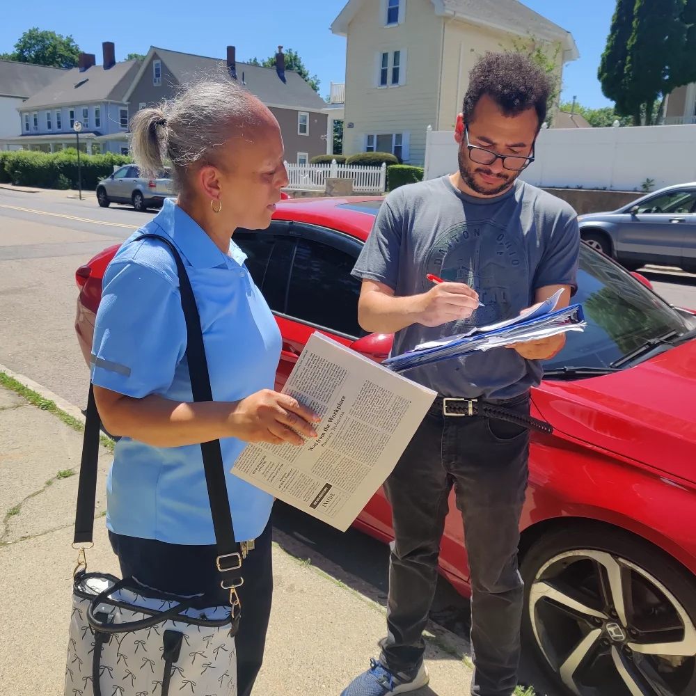 ESWA volunteer signs up a new member.