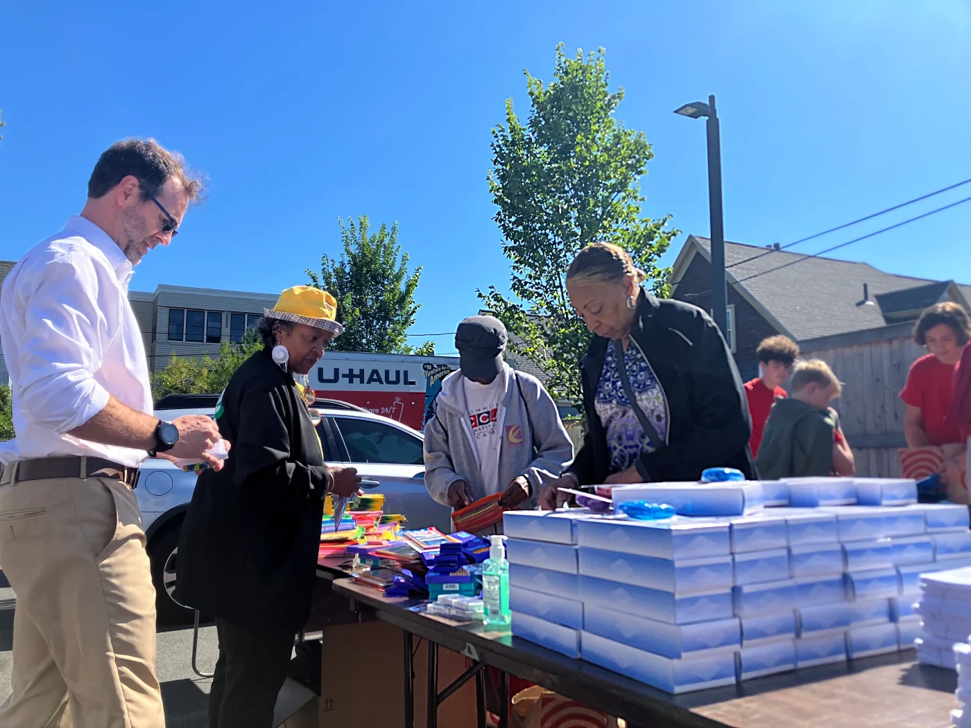 Photo of ESWA volunteers sorting school supplies.