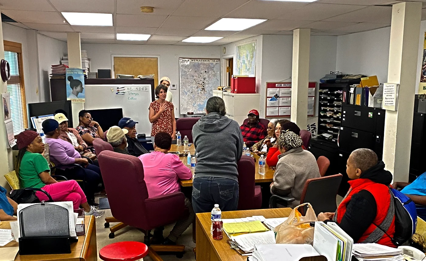 Photo of ESWA volunteer doctor speaking to a group of members.