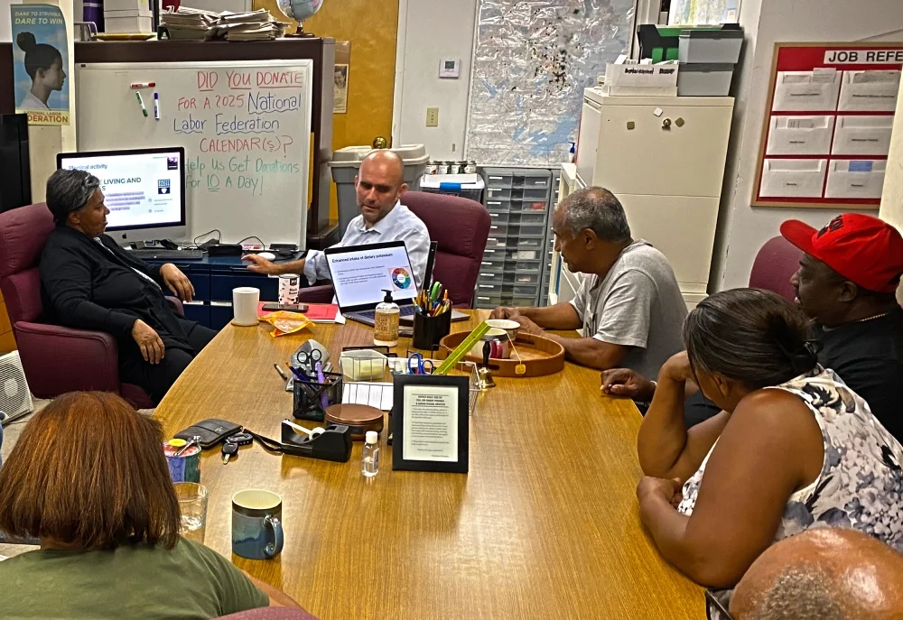 Photo of a volunteer physician doing a presentation to a group of ESWA members.