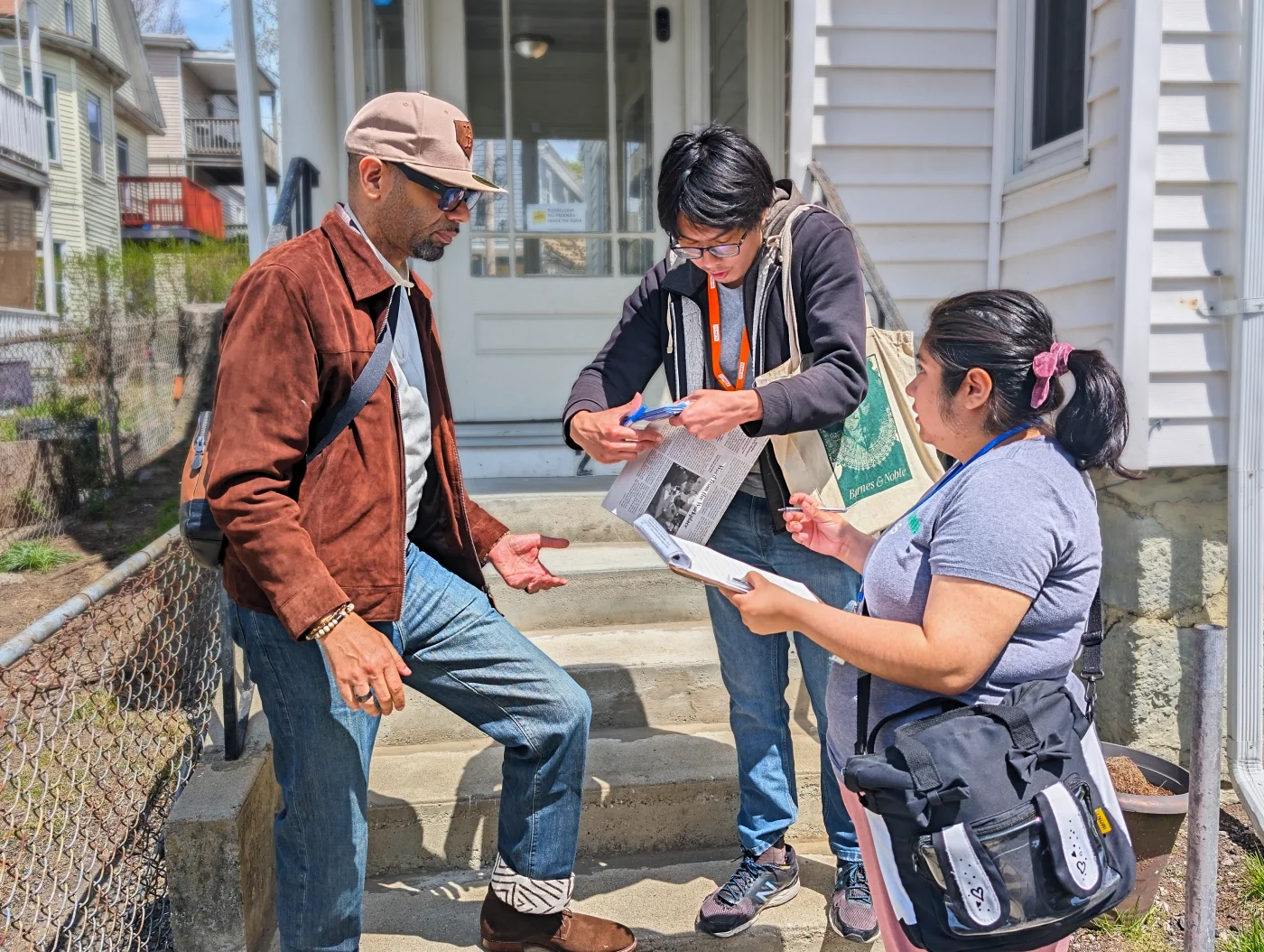 Two volunteers sign up a new ESWA member in their neighborhood.