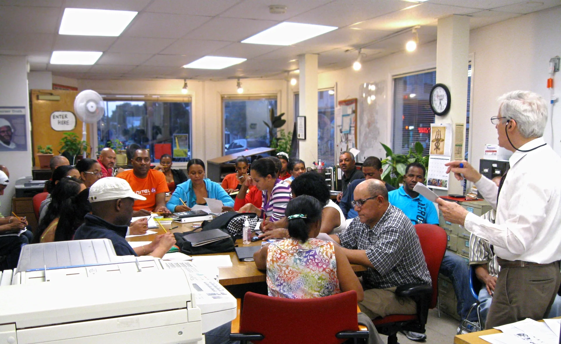ESWA volunteer teaching English to a room full of members.