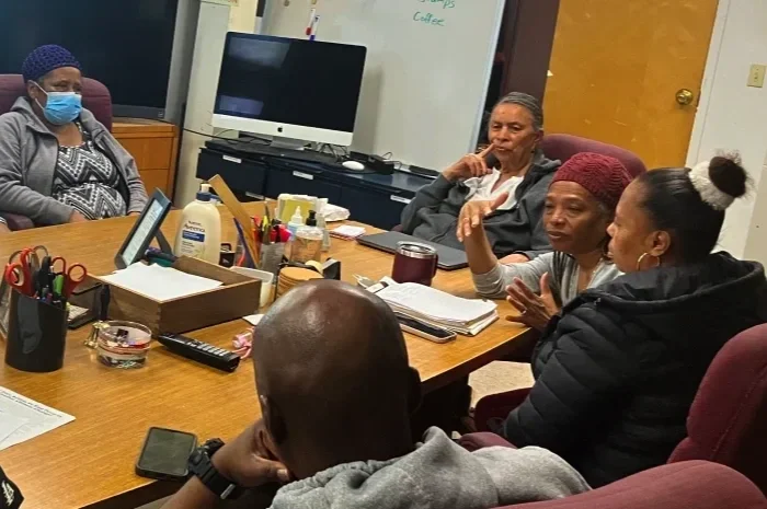 ESWA delegate speaking and gesturing at a meeting as other members listen.