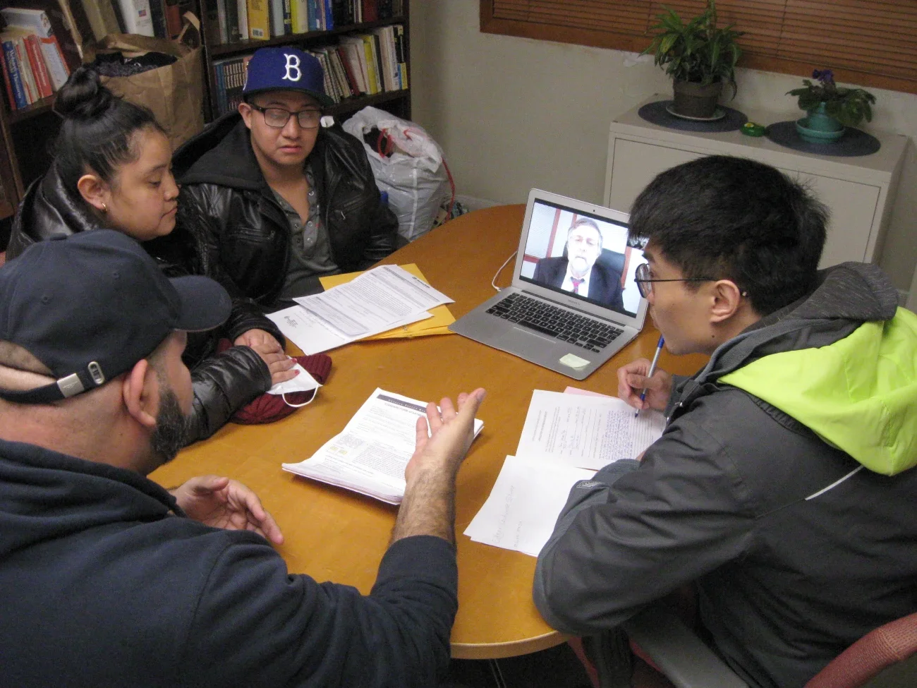 Volunteer advocate with member family consulting with a volunteer lawyer over Zoom.