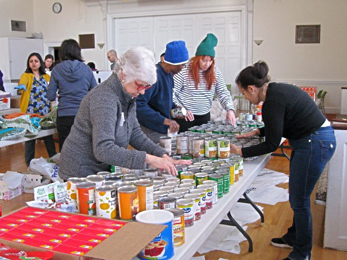 Volunteers sorting canned food.