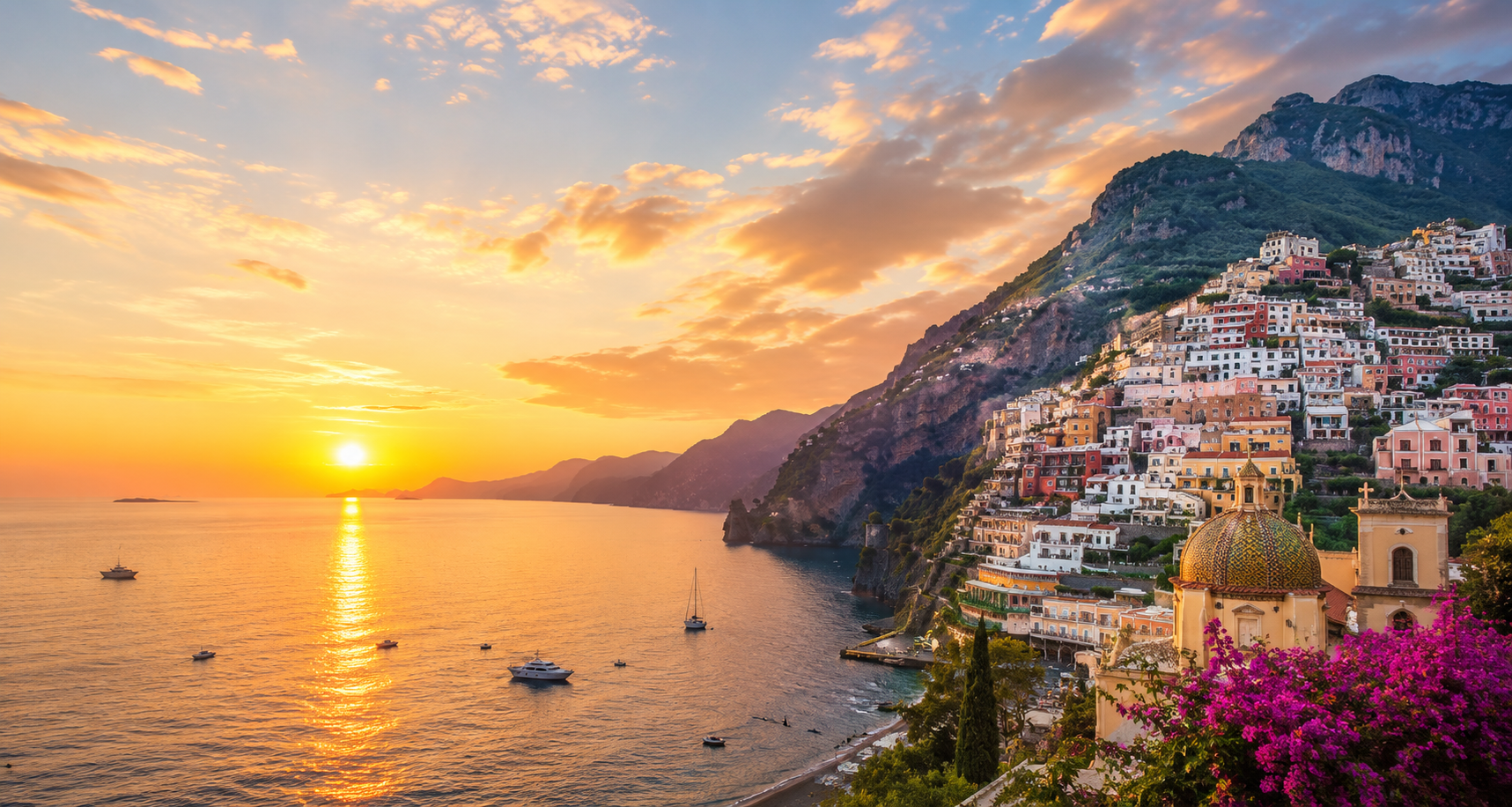 Sunset over the ocean with boats, colorful houses on a hillside, and a church with colorful domes in a coastal town.