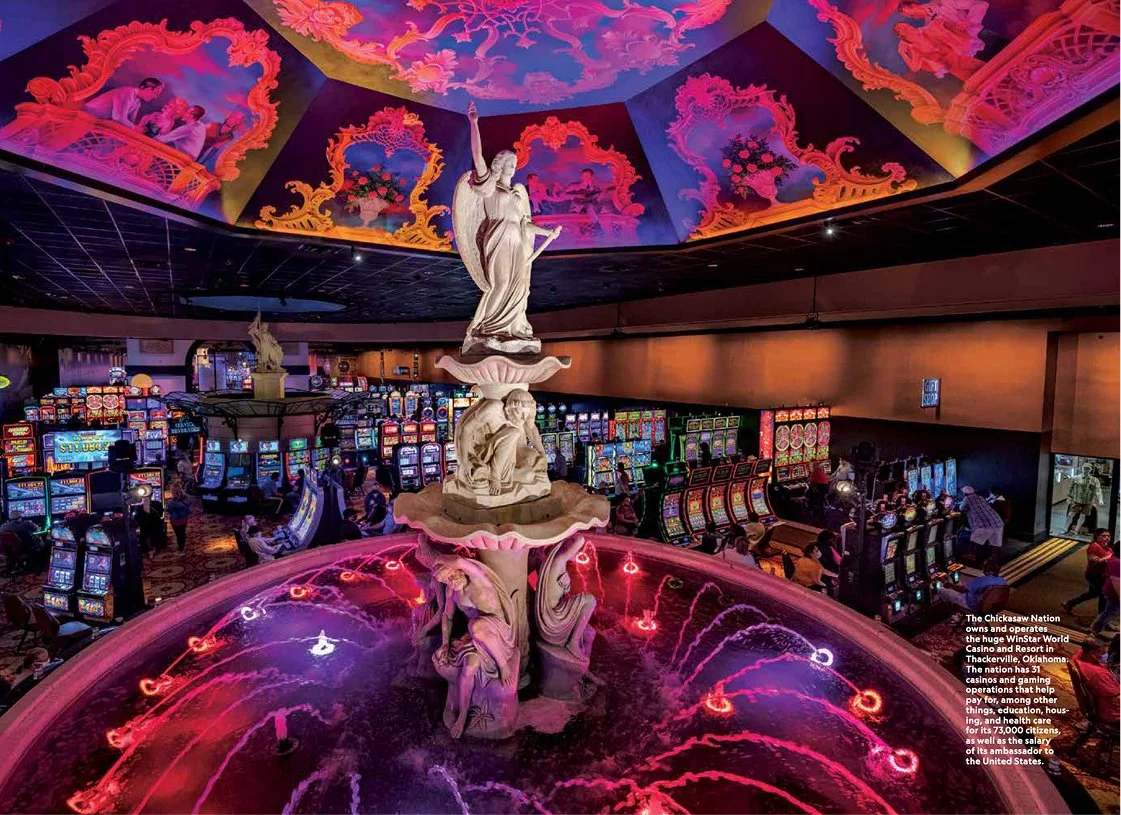 Indoor casino with a central fountain featuring statues and a colorful painted ceiling
