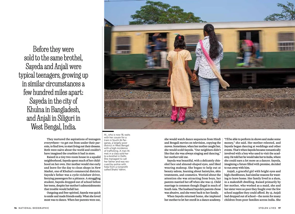 A magazine spread featuring text and a picture of two girls, one in a yellow dress and the other in jeans and a top, holding hands and standing on a train platform, watching a passing train.
