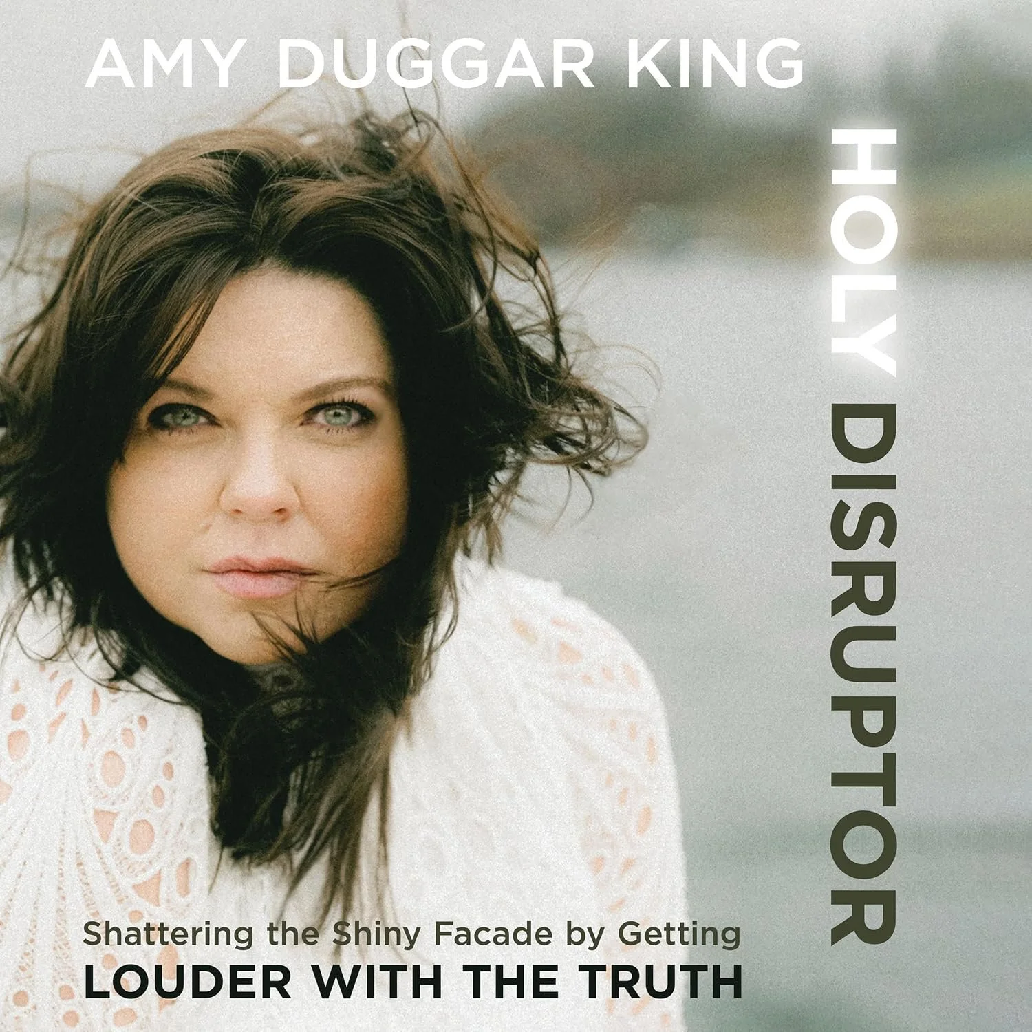 Book cover featuring a woman with dark brown hair and piercing blue eyes, wearing a white lace top, with vertical text saying 'AMY DUGGAR KIRKPATRICK' on the right and a subtitle. The background is outdoors with a blurred natural setting.