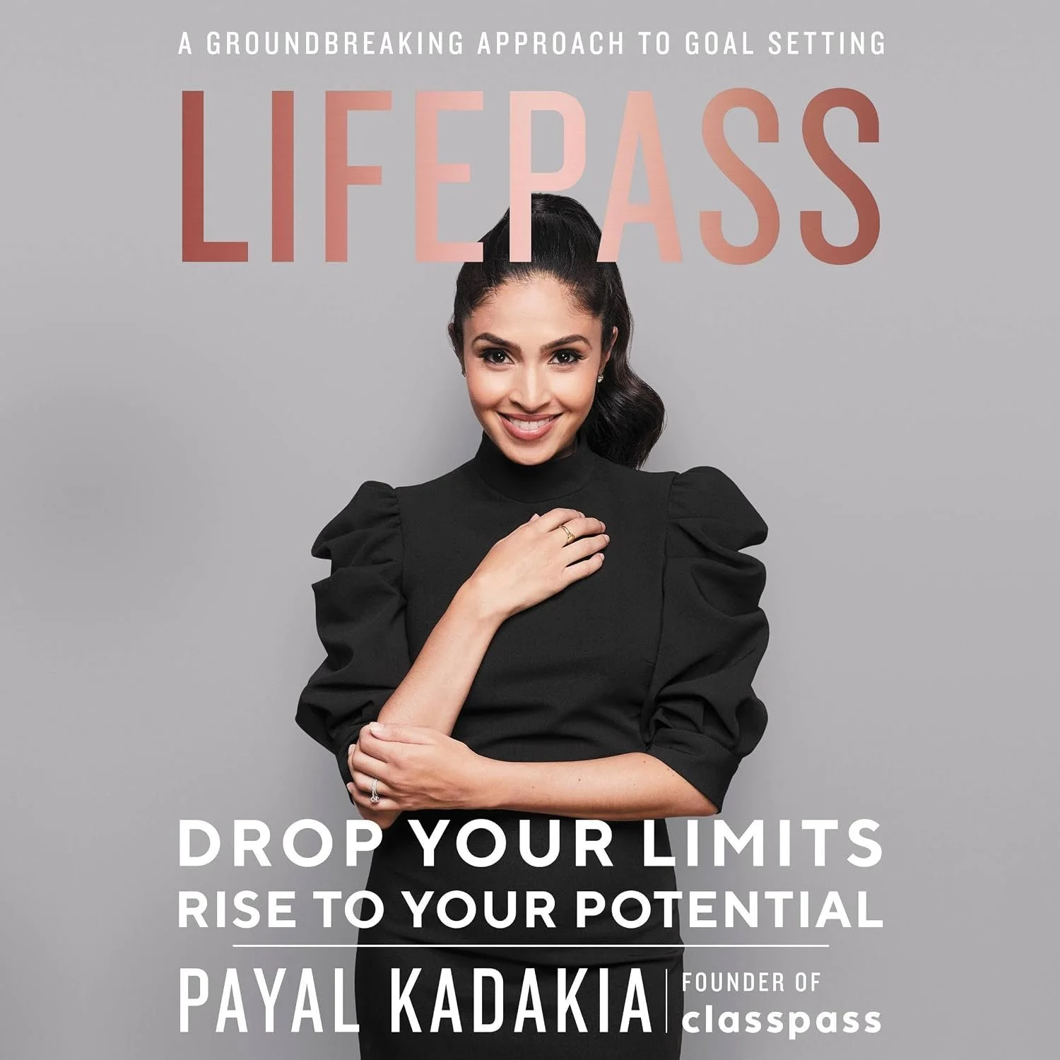 A woman in a black dress with puffed sleeves smiles with her hand on her chest. The background contains motivational text promoting goal setting and personal development, including the words 'LIFE PASS', 'DROP YOUR LIMITS', and 'RISE TO YOUR POTENTIAL'. The woman is identified as Payal Kadakia, founder of ClassPass.