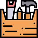 A wooden toolbox containing a wrench, a hammer, and two small bottles.