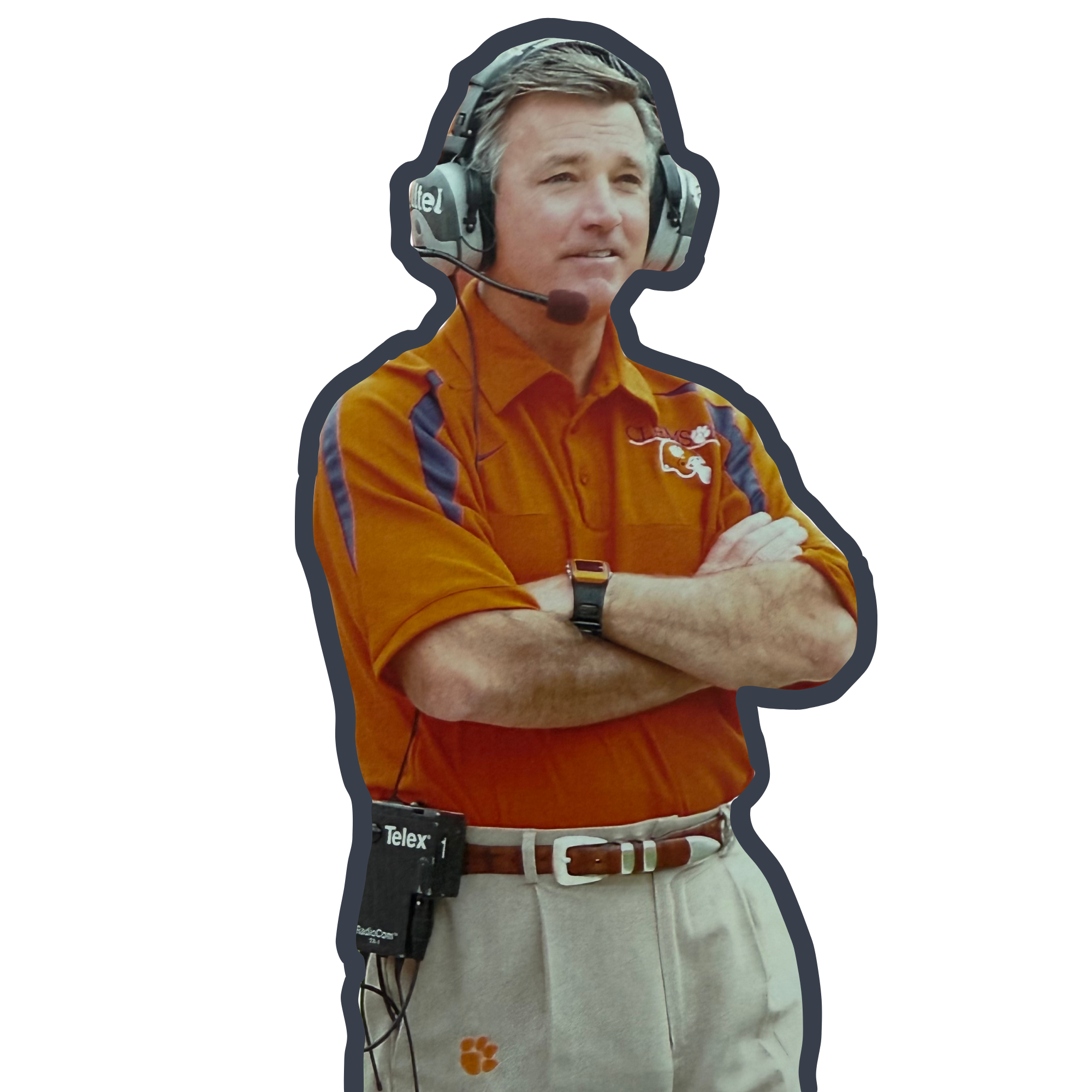 Tommy Bowden on the sidelines at a football game in his Clemson shirt, khakis, and with a headset on.