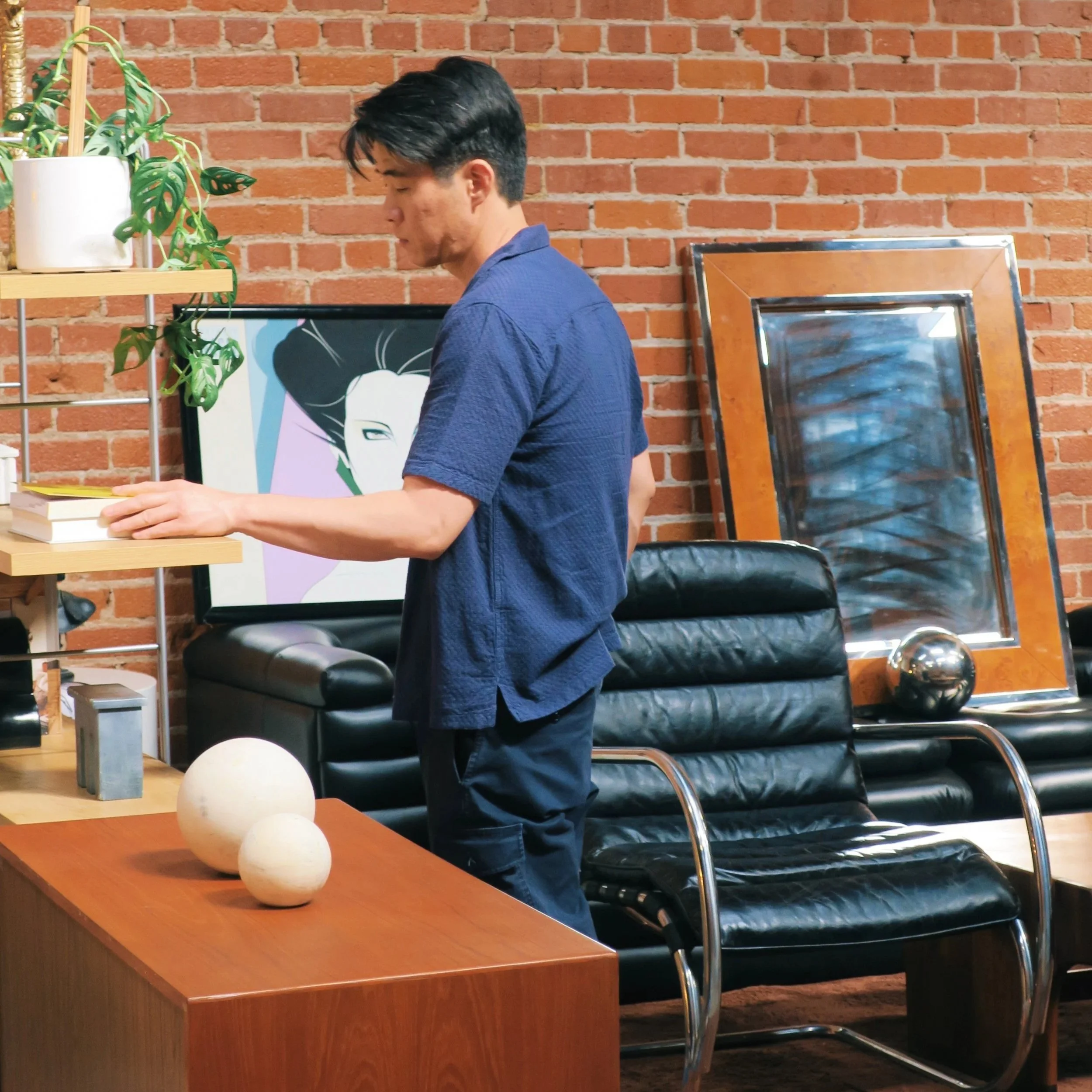 A patron admires some iconic vintage pieces, courtesy of Shop Vintage Plug.