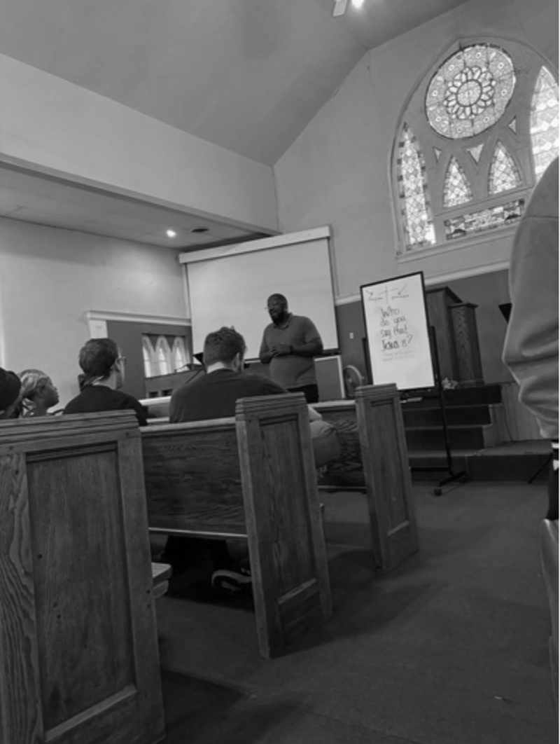 Pastor Akin teaching a class with students