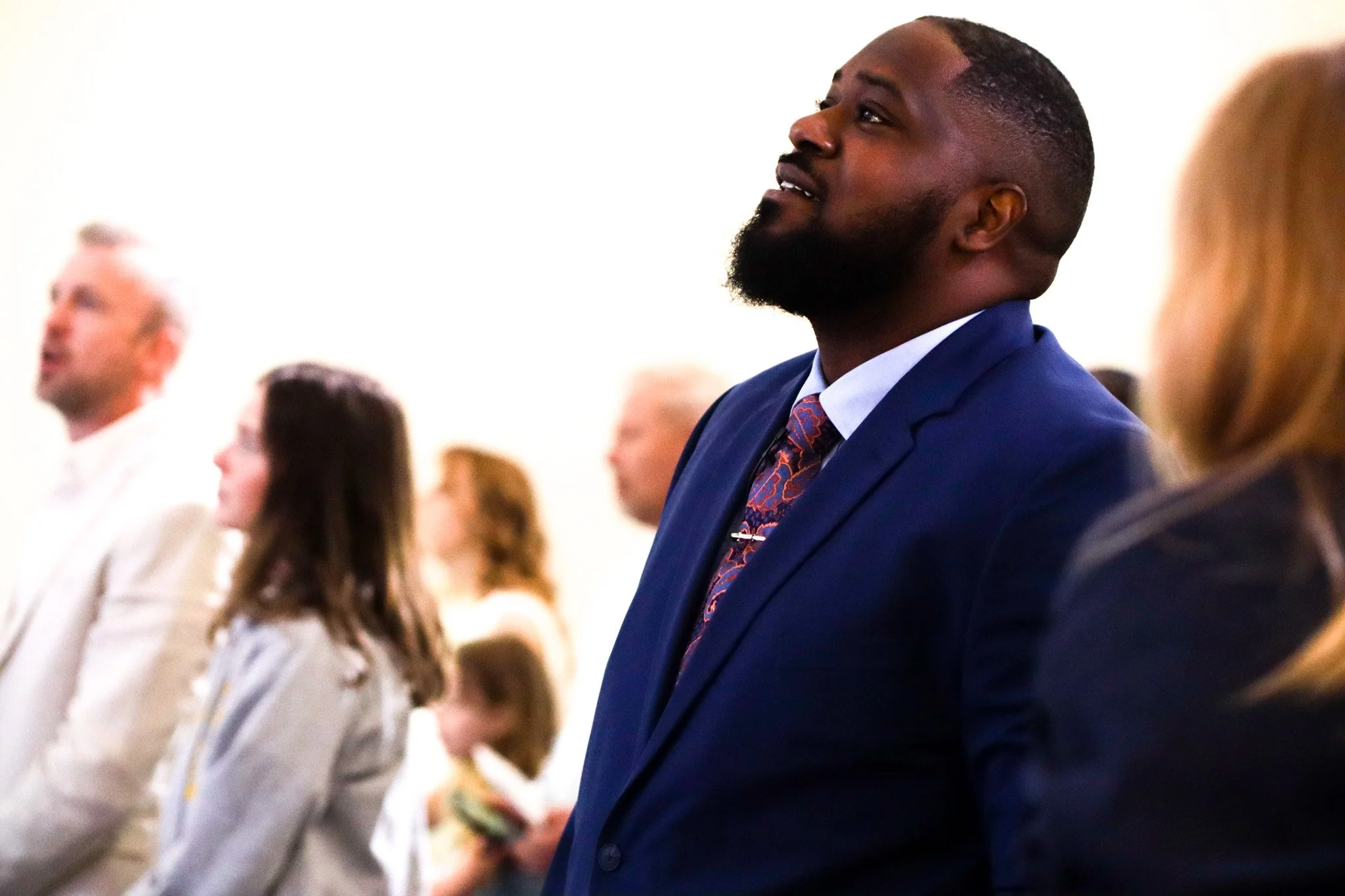 Pastor Akin singing with the church family