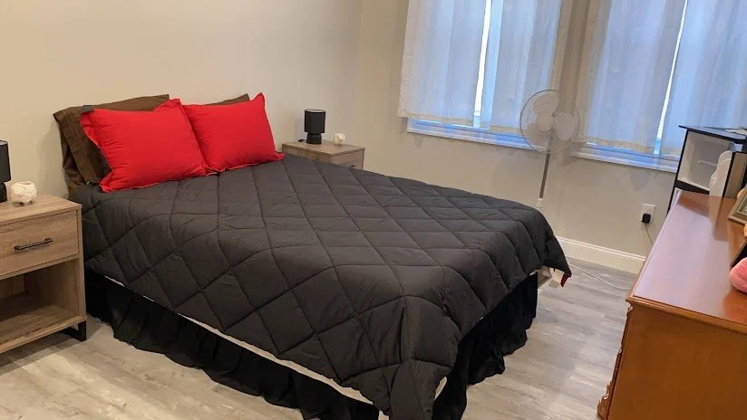 Neatly made bed prepared for guests after an Airbnb turnover cleaning.