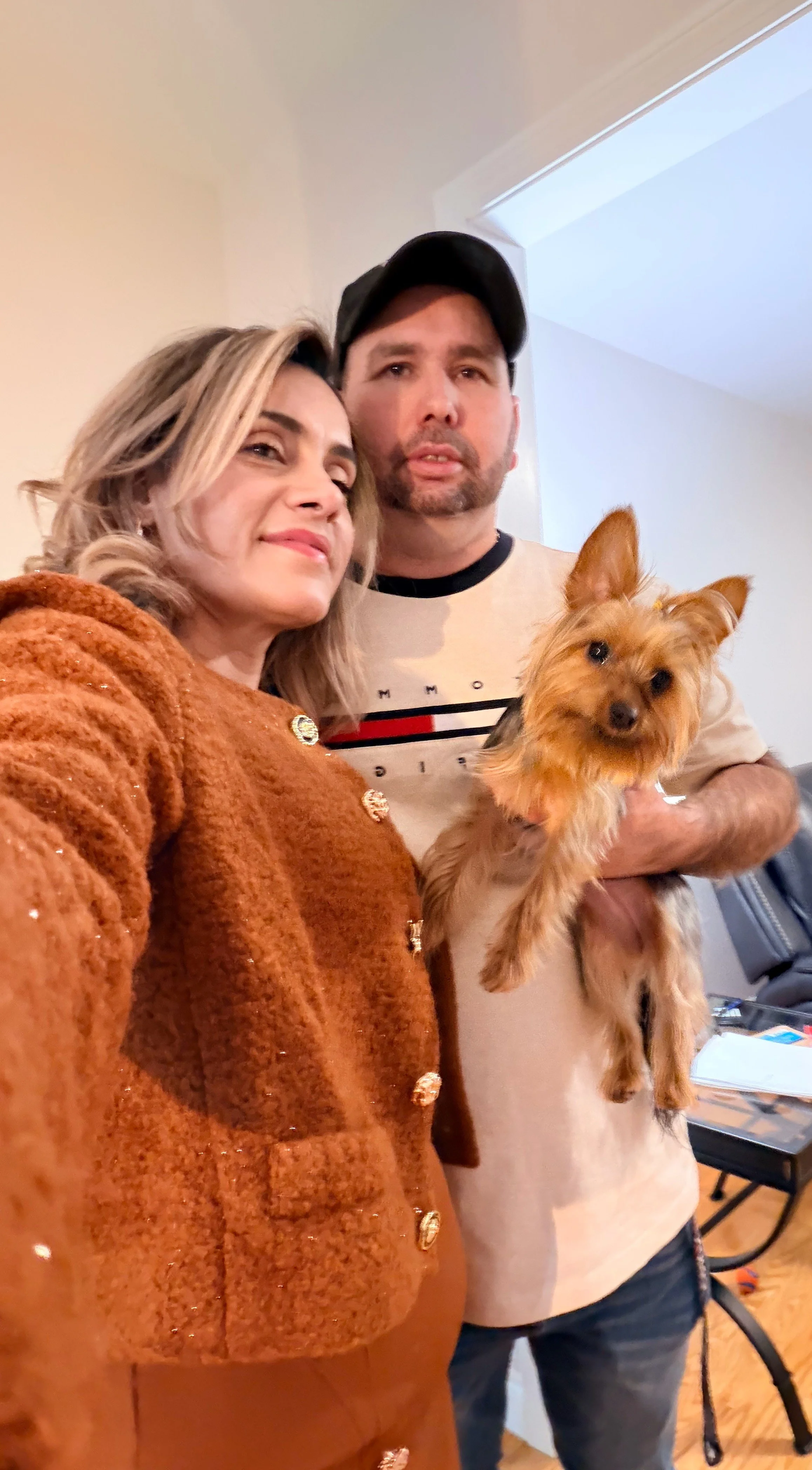 Débora and Reginaldo with Zoe, the mascot of Meireles Cleaning Services.