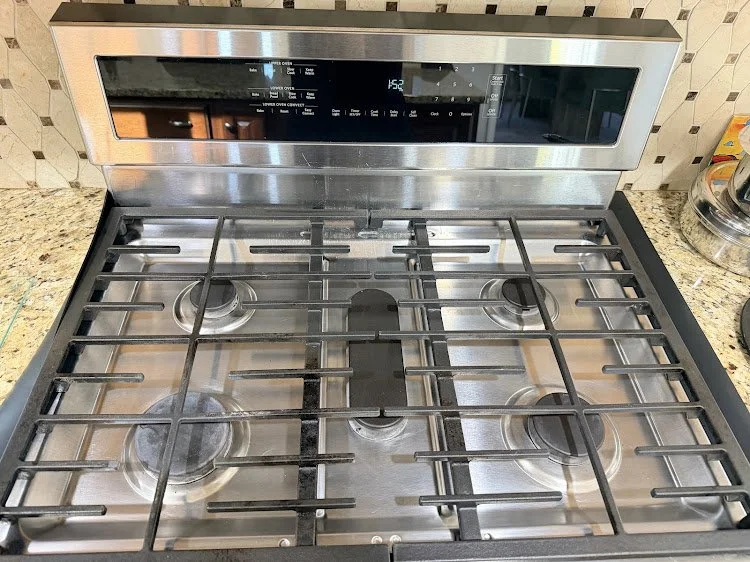 Clean and polished cooktop after a standard residential cleaning.