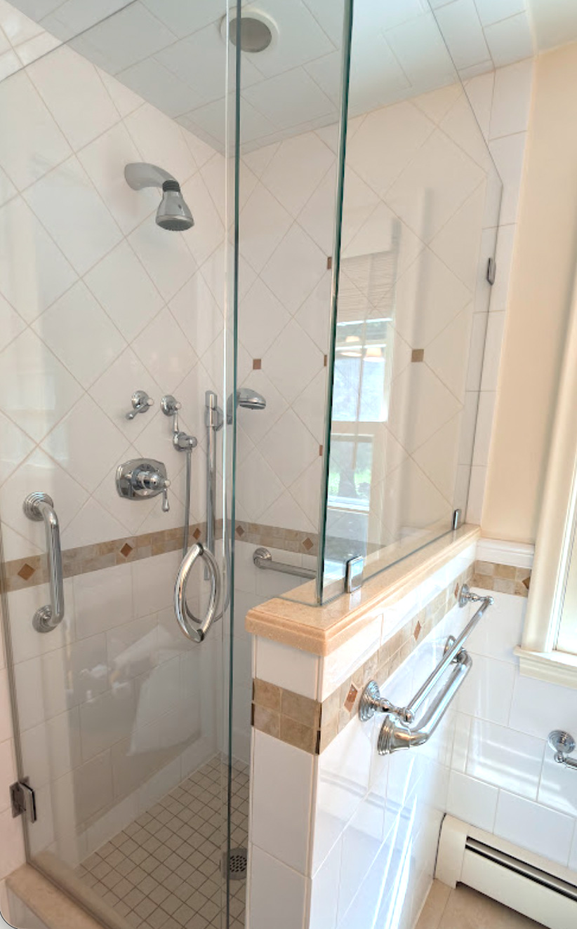 Spotless bathroom with a deeply cleaned glass shower enclosure.