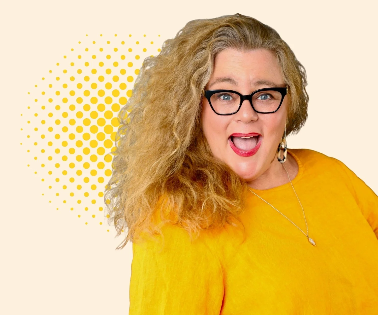 A woman with long, curly blonde hair wearing black glasses, a yellow top, earrings, and a necklace, smiling with her mouth open in front of a beige background with yellow dots.