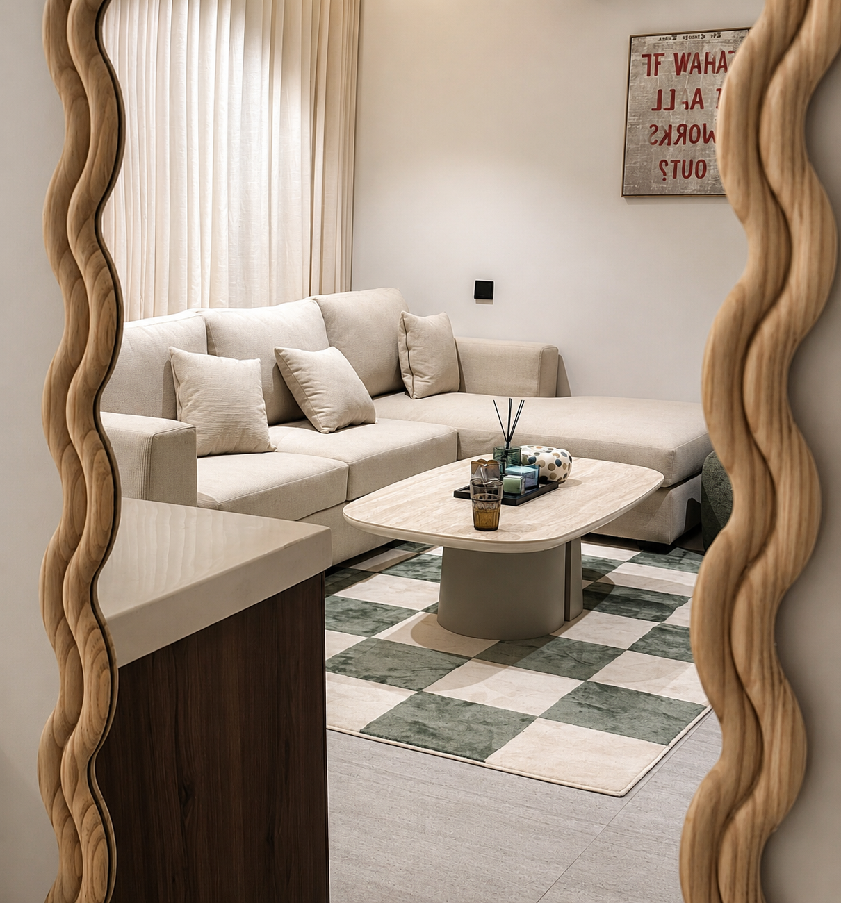 Living room reflected in a wavy framed mirror, featuring a beige sectional sofa with pillows, a rectangular coffee table with decorative items, a checkered green and white rug, and a wall art piece.