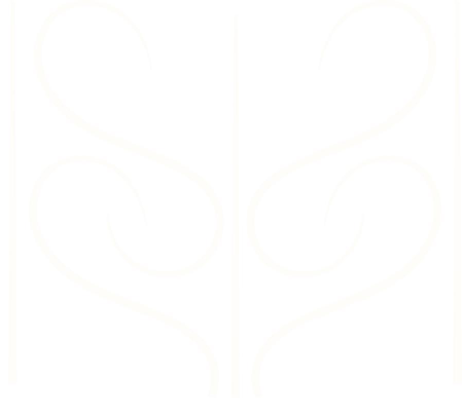 Decorative black and white iron gate with symmetrical swirling patterns.