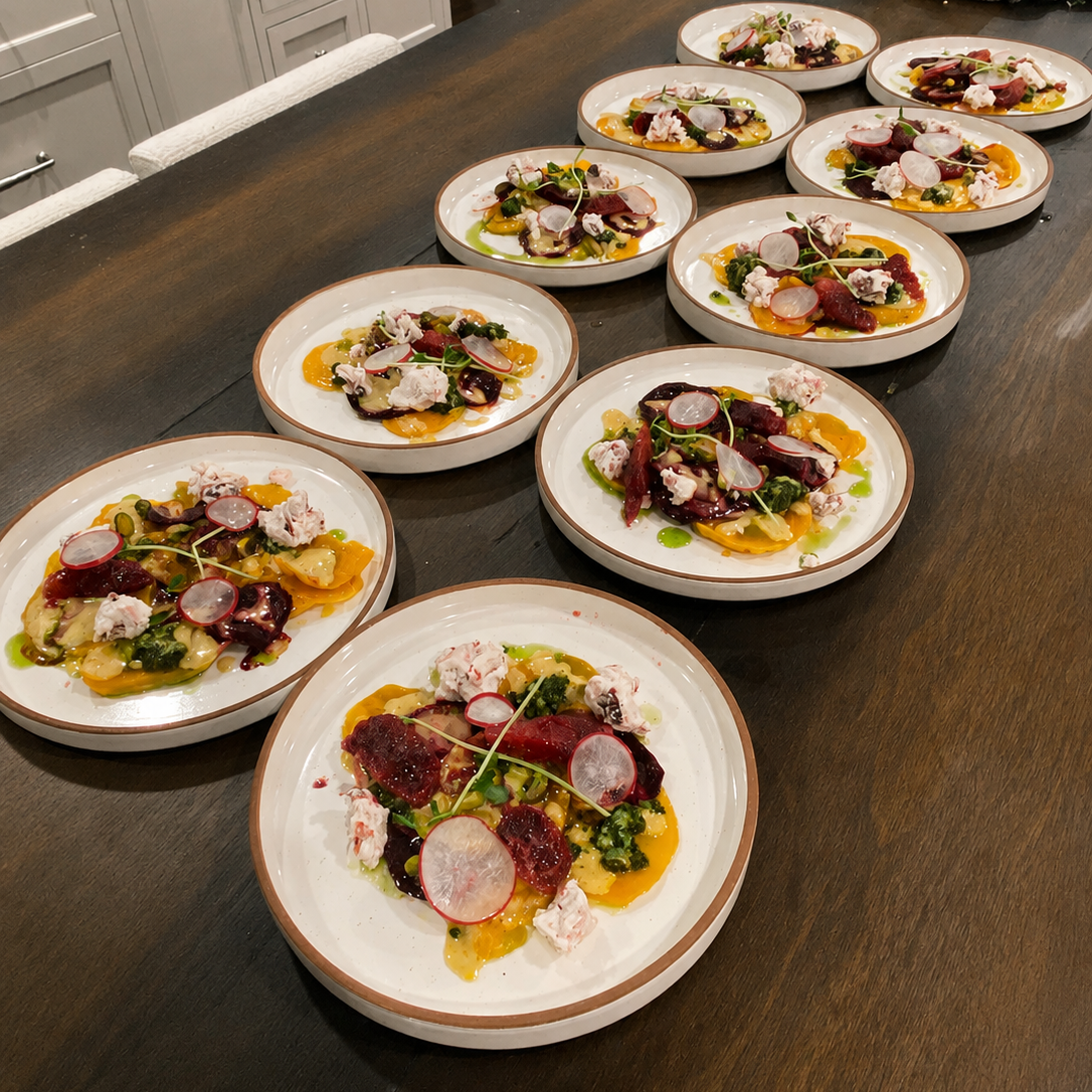 Eleven plates of colorful gourmet salad with radishes, beets, greens, and cheese, arranged on a dark wooden table.
