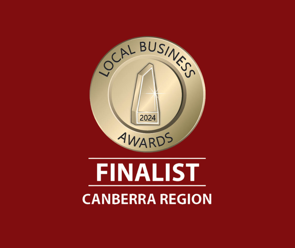 Gold medal with black border and text reading "Local Business Awards 2024" and the number 1 in the center, on a red background. Below, the text "FINALIST" in bold white letters, with "Canberra Region" underneath.