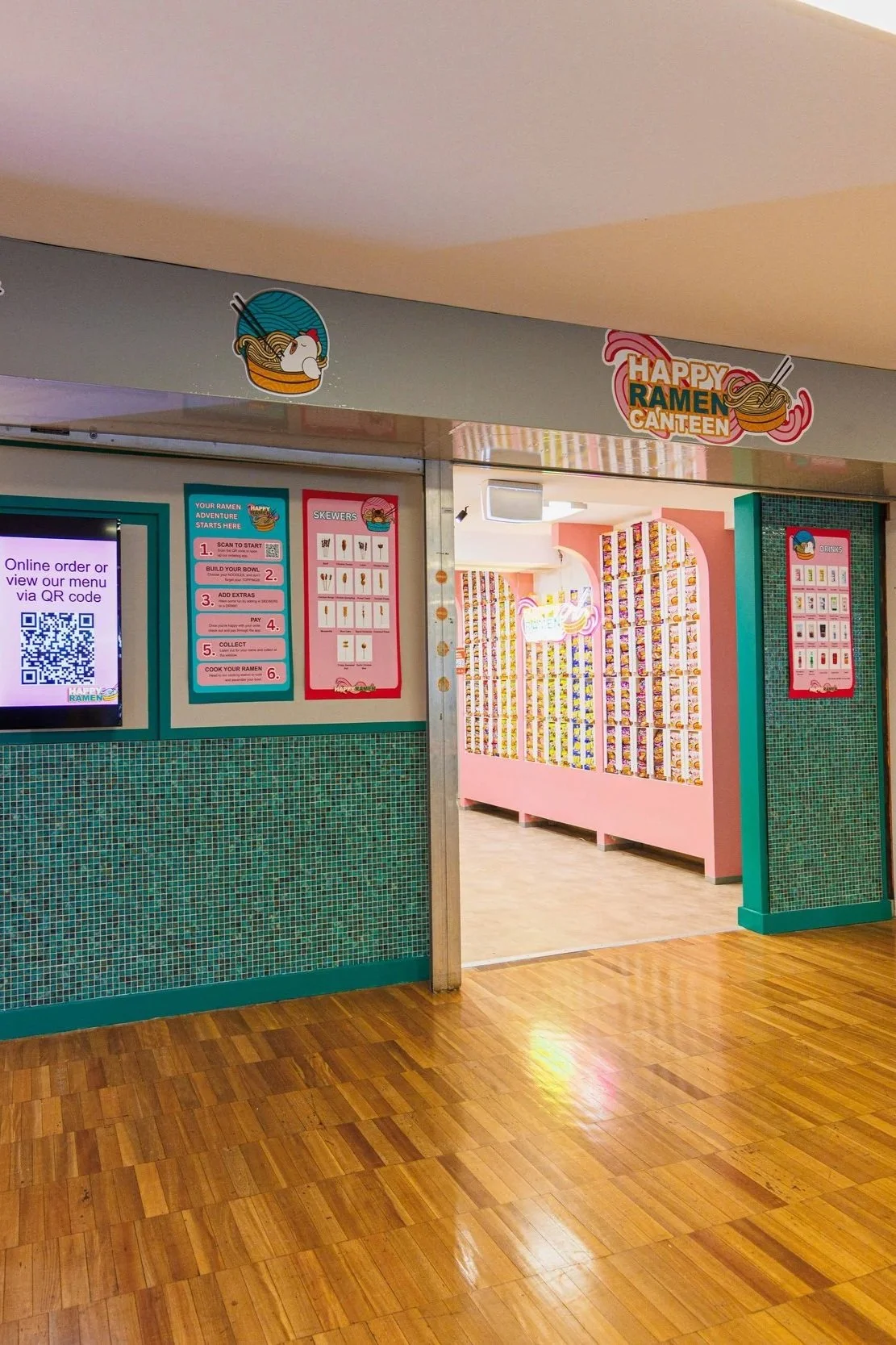 Entrance to a ramen restaurant called 'Happy Ramen Canteen' with menu and ordering instructions on the wall.