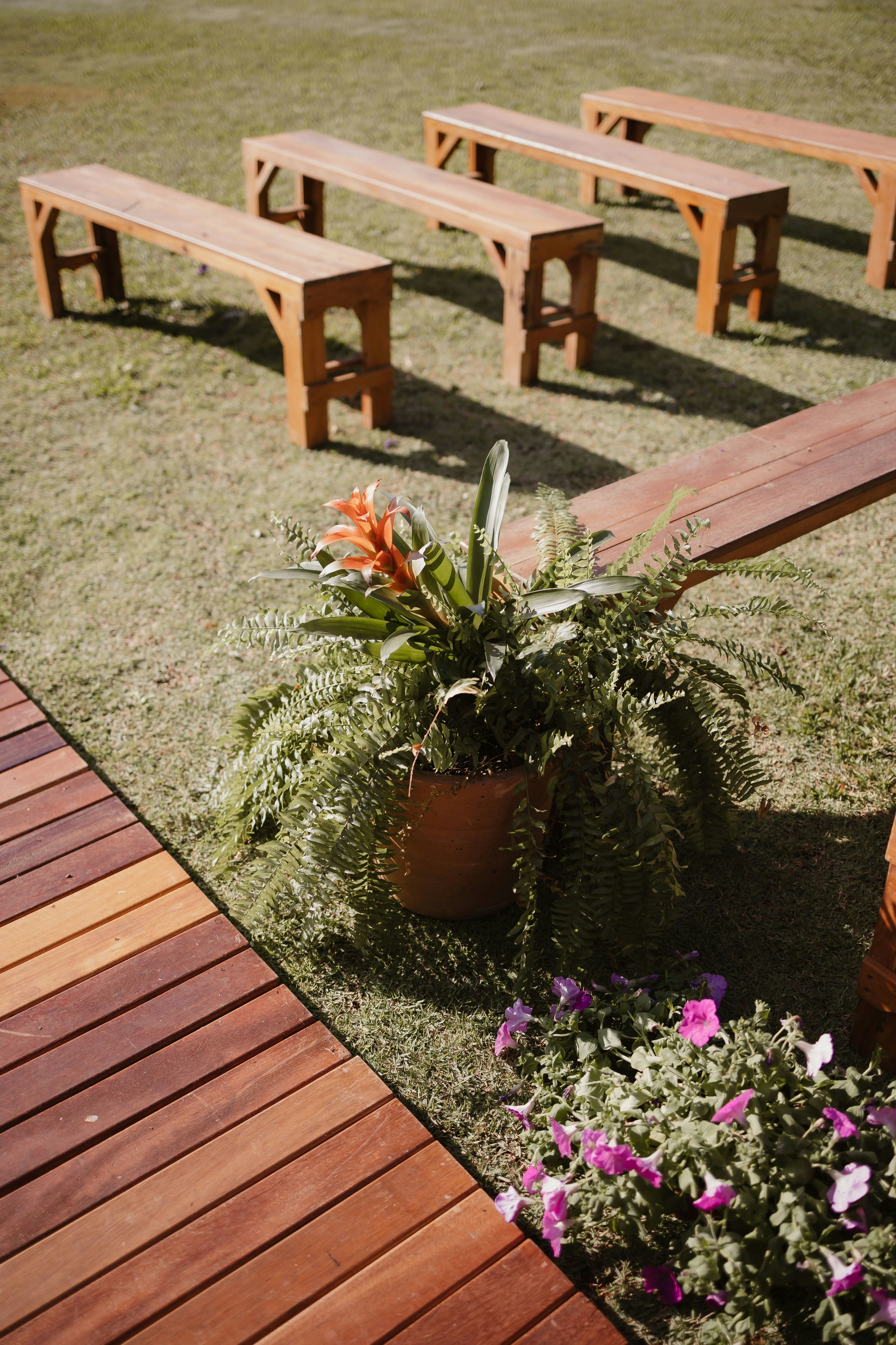 Outdoor timber benches and ceremony styling for a rustic country wedding, managed by coordinator Sandstone and Fern.