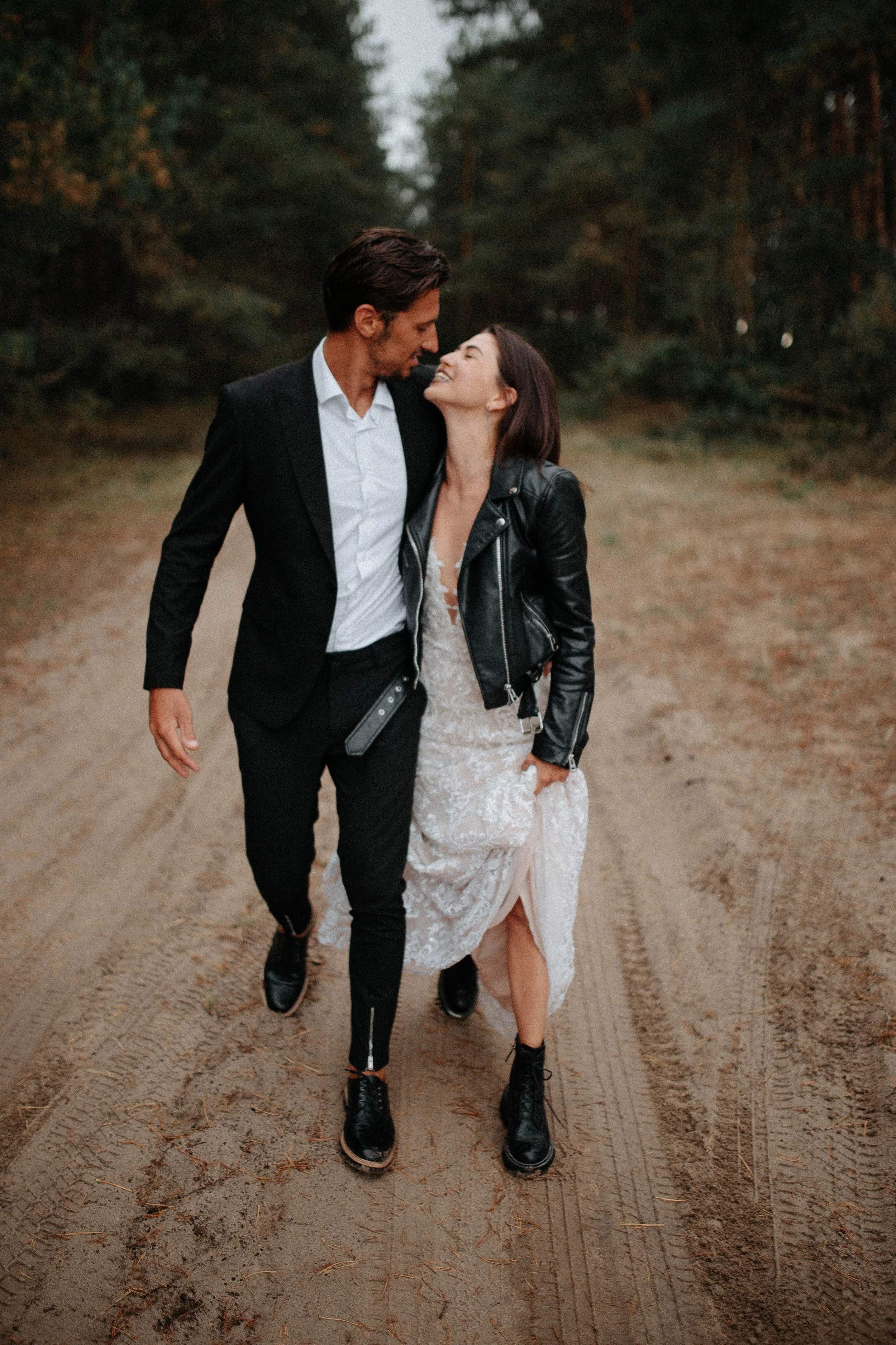 An alternative newlywed couple sharing a quiet moment on a rural property.