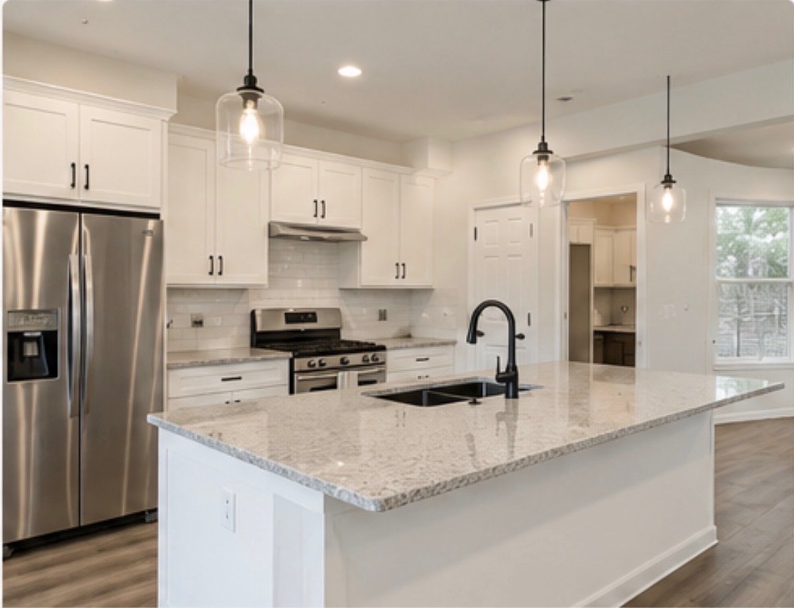 Modern kitchen with white cabinets, stainless steel refrigerator, black stove, granite countertop island, black faucet, pendant lights, wood flooring, and a window.