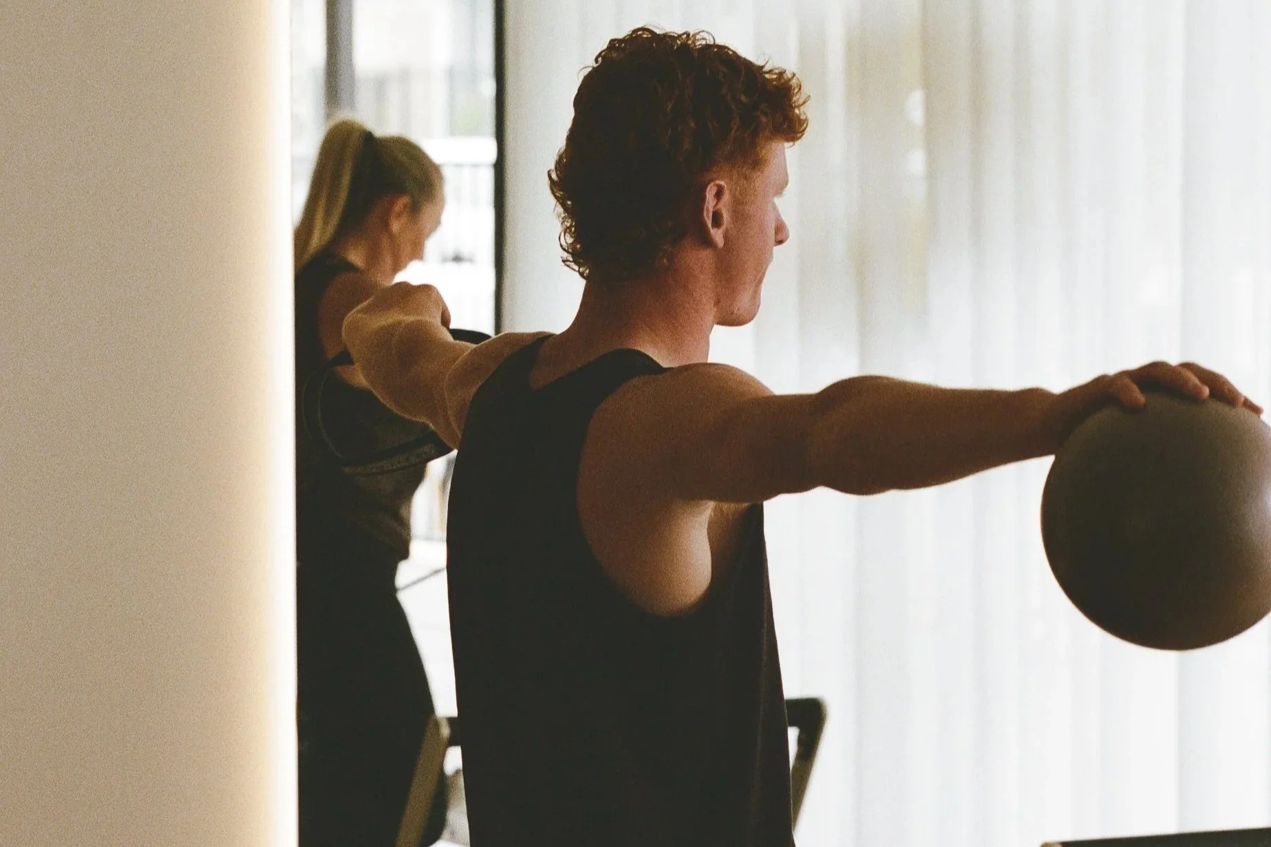 Man exercising on pilates reformer