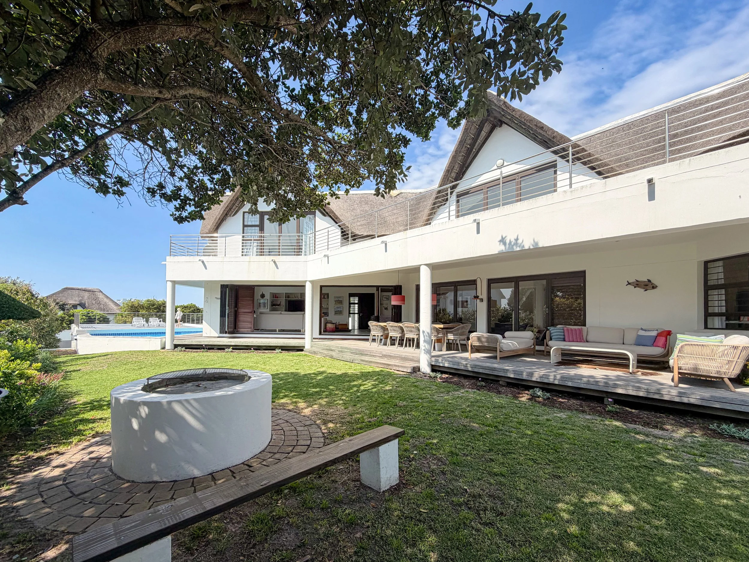 St Francis Beach House exterior with pool and covered patio, viewed from the garden