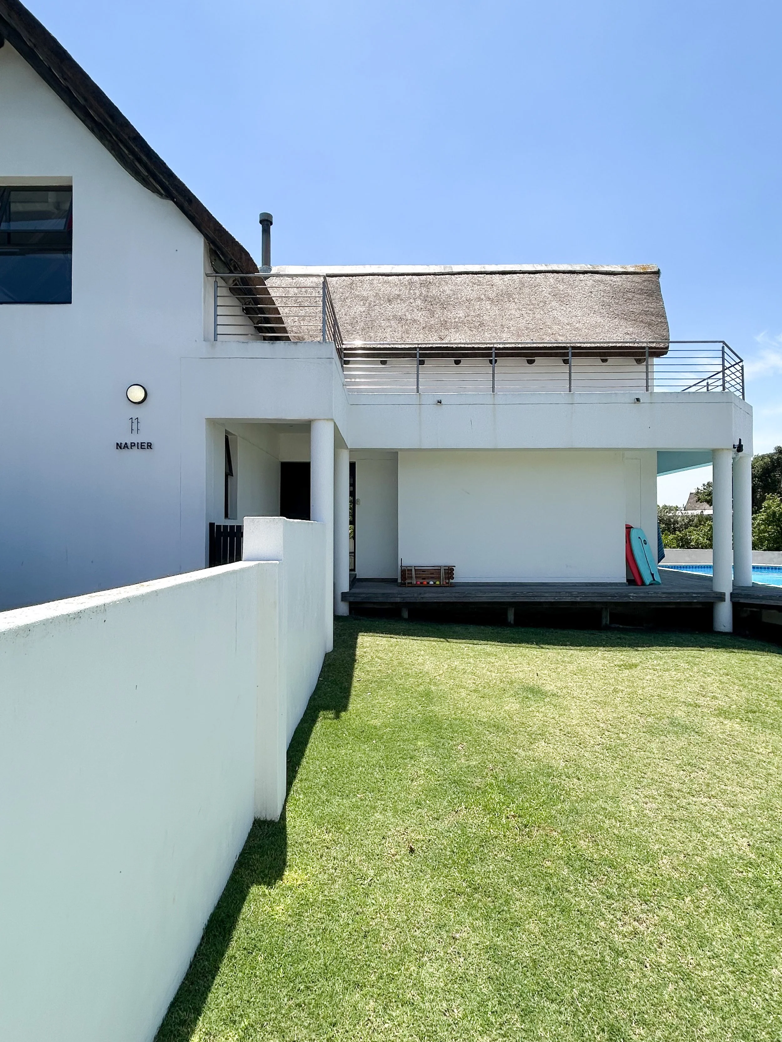 Rear exterior of the house showing the "11 Napier" house number and back lawn