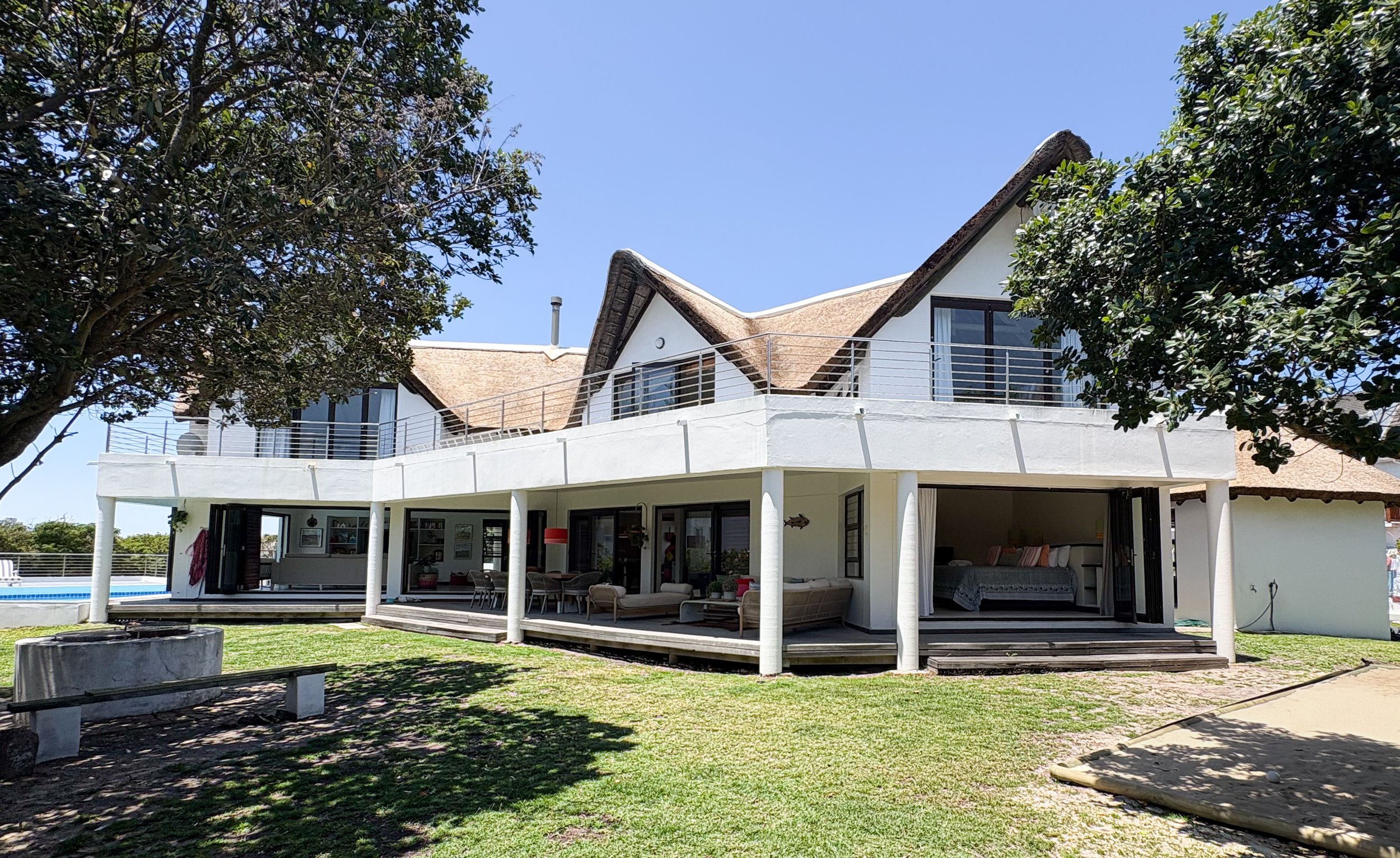 Full exterior view of the house with fire pit in the foreground