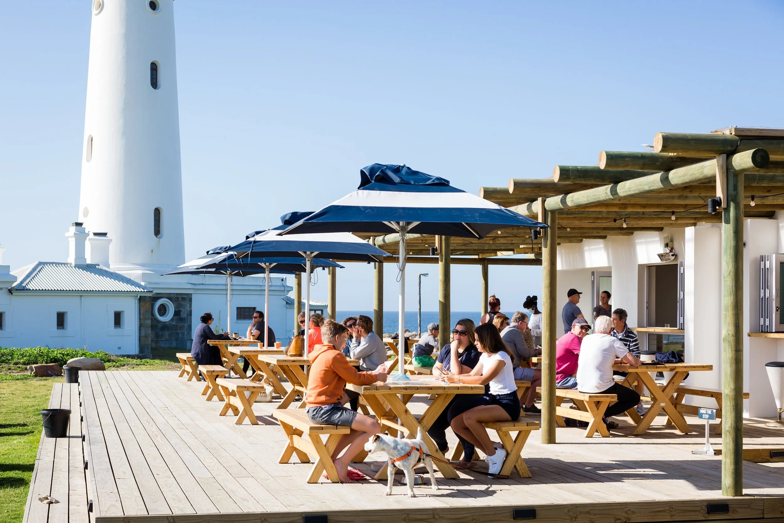 Diners at a seafood restaurant deck near the Seal Point lighthouse, Port St Francis