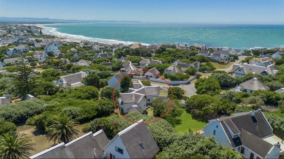 Aerial view of the neighbourhood with St Francis Beach House circled, beach and sea beyond
