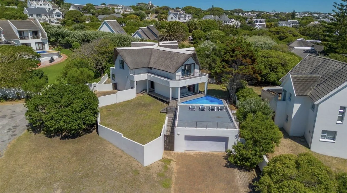 Aerial view of the house showing the pool, garden, and driveway