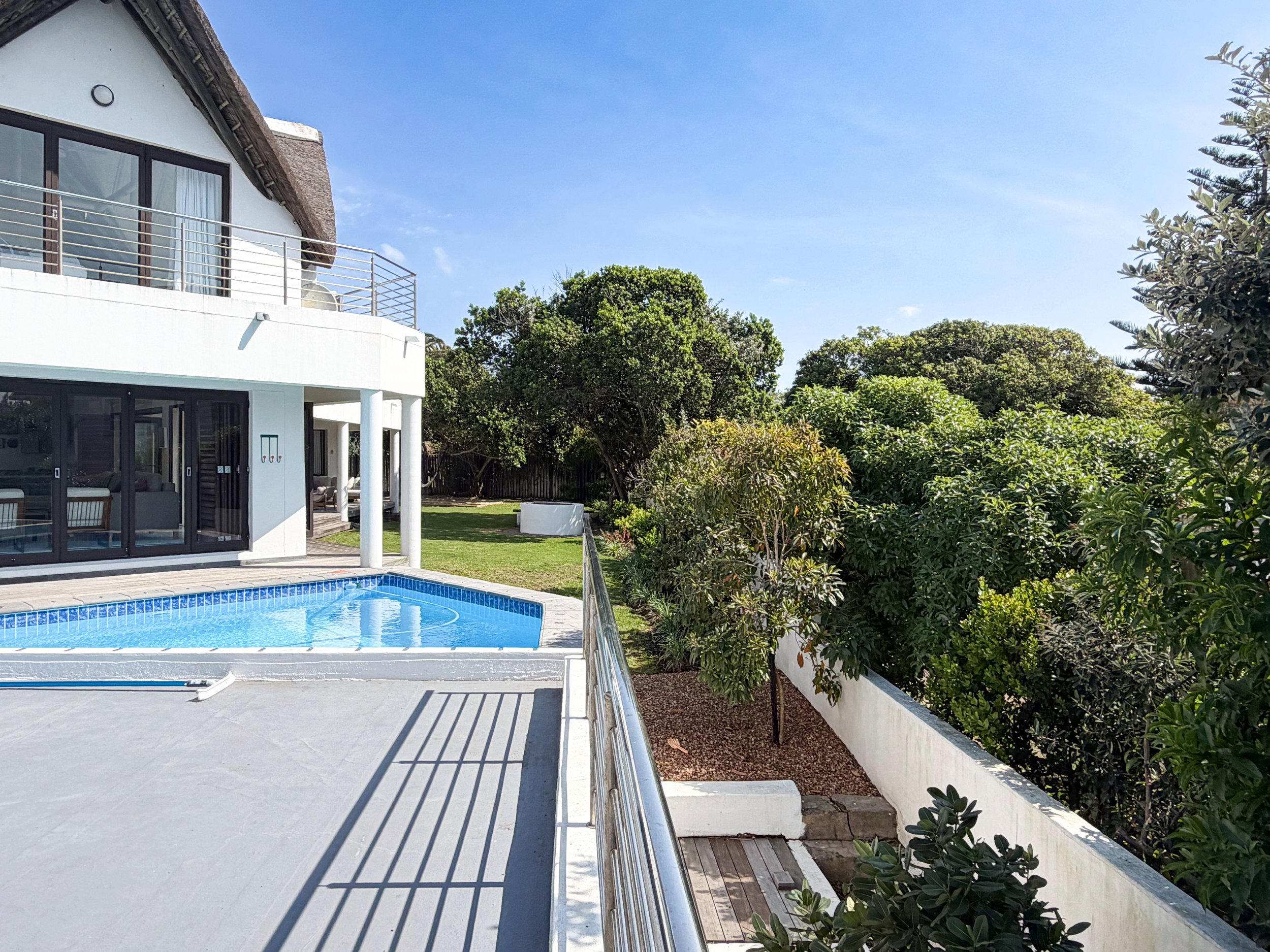 Pool and garden view from the upstairs deck at St Francis Beach House
