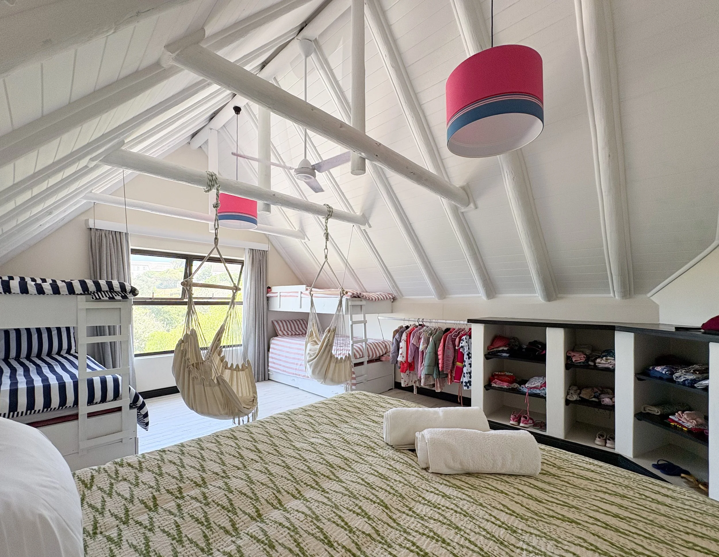 Wide view of the dorm room showing bunk beds and storage