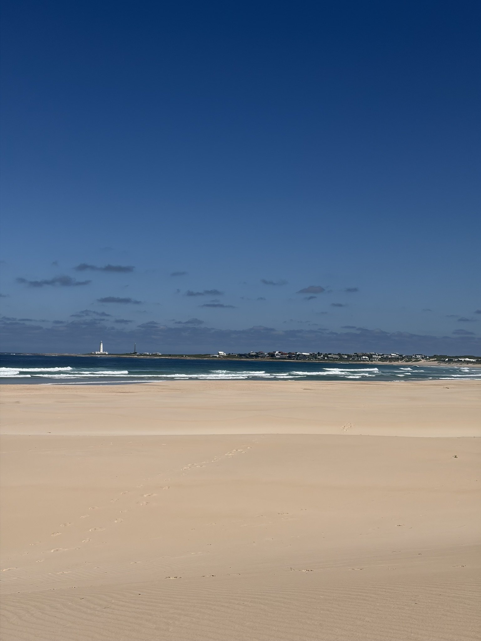 beach with the Seal Point Lighthouse visible