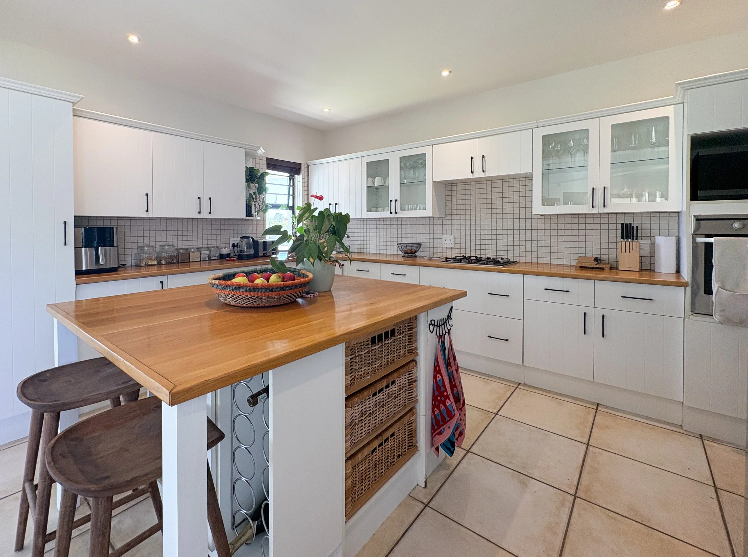 Kitchen with island, wooden countertop, and bar stool seating